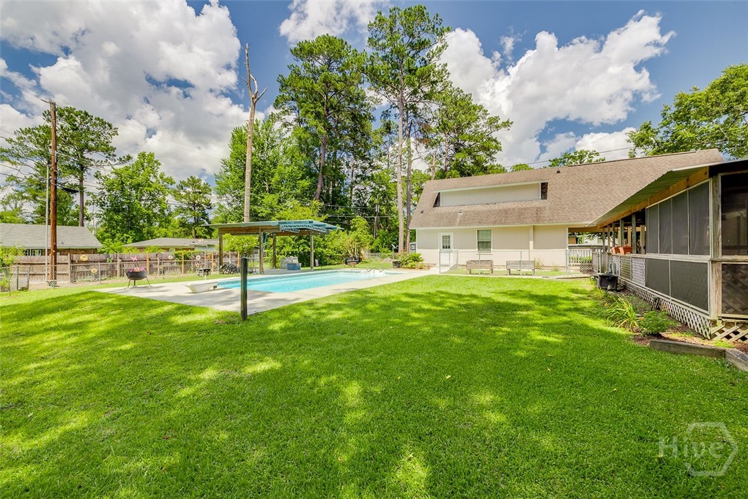 218 Whitehall Avenue Rincon, GA 31326 - Photo 31 of 42 BACKYARD VIEW OF POOL, GARAGE & BACK PORCH