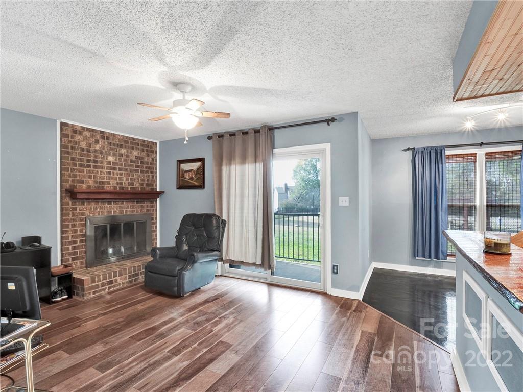11060 Running Ridge Road Charlotte, NC 28226 - Photo 3 of 16 a living room with furniture floor to ceiling window and a flat screen tv