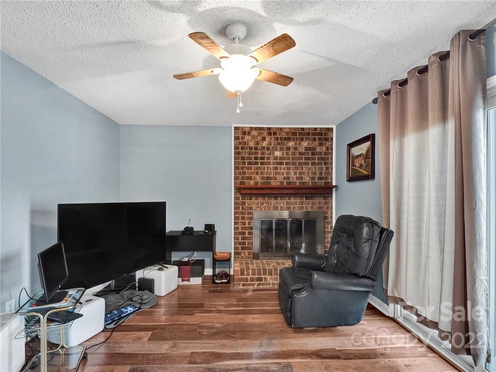 11060 Running Ridge Road Charlotte, NC 28226 - Photo 5 of 16 a living room with furniture a flat screen tv and a fireplace