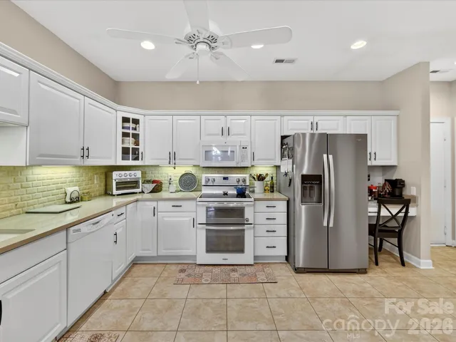 a kitchen with stainless steel appliances granite countertop a sink and cabinets
