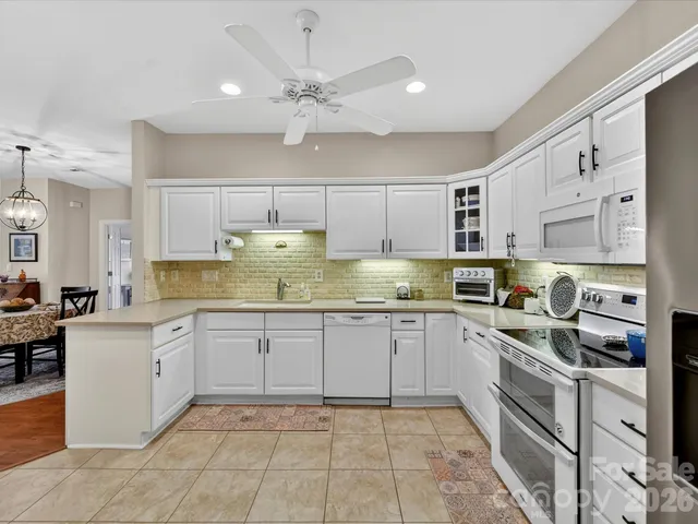 a kitchen with a cabinets a sink stainless steel appliances and cabinets