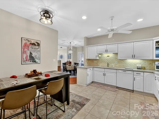 a kitchen with stainless steel appliances granite countertop a stove refrigerator and a sink with granite countertops