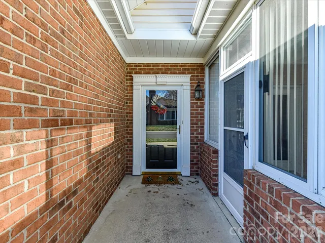 a living room with furniture a fireplace and a window
