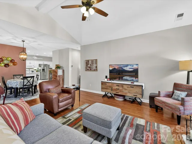 a living room with furniture fireplace and a flat screen tv