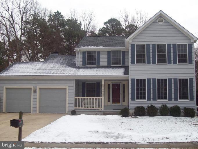 603 Pasture Brook Road Severn, MD 21144 - Photo 1 of 22 a front view of a house with a yard covered in snow