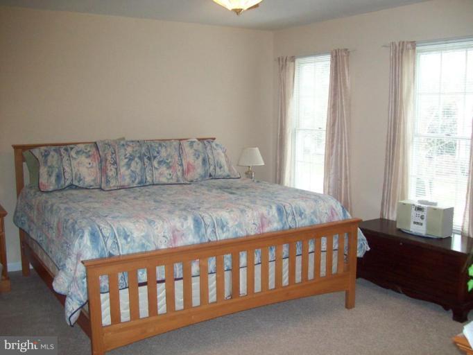 603 Pasture Brook Road Severn, MD 21144 - Photo 12 of 22 a bedroom with a bed and a couch