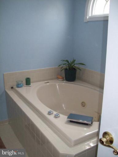 603 Pasture Brook Road Severn, MD 21144 - Photo 15 of 22 a bath tub sitting in a bathroom