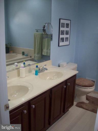 603 Pasture Brook Road Severn, MD 21144 - Photo 16 of 22 a bathroom with a sink vanity and toilet