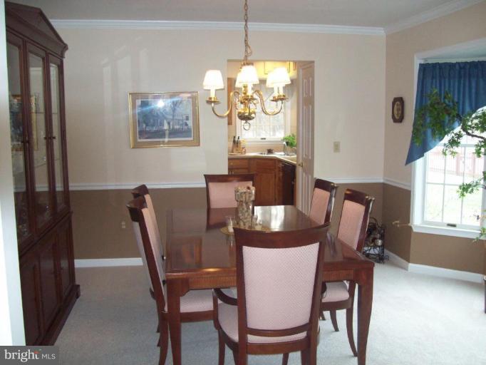 603 Pasture Brook Road Severn, MD 21144 - Photo 5 of 22 a view of a dining room with furniture window and outside view