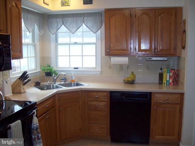 603 Pasture Brook Road Severn, MD 21144 - Photo 6 of 22 a kitchen with stainless steel appliances granite countertop a sink a stove cabinets and a counter top space