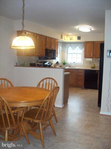 603 Pasture Brook Road Severn, MD 21144 - Photo 8 of 22 a kitchen with a table and chairs in it