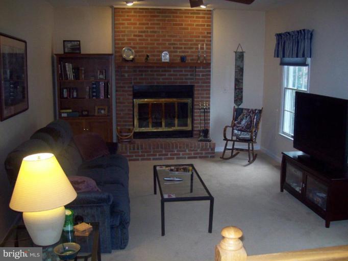603 Pasture Brook Road Severn, MD 21144 - Photo 9 of 22 a living room with furniture and a fireplace