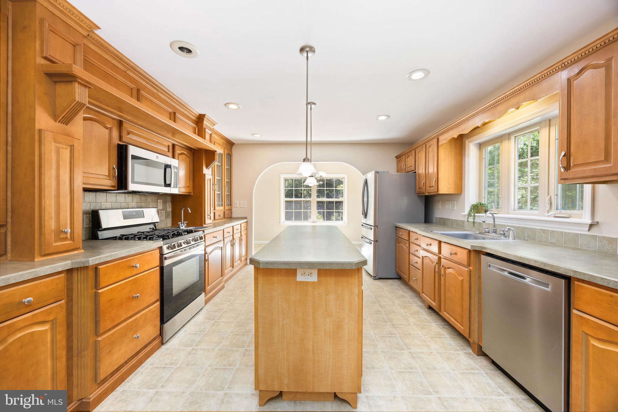 6635 Libertytown Road Berlin, MD 21811 - Photo 17 of 88 a large kitchen with stainless steel appliances granite countertop a stove a sink dishwasher and a refrigerator