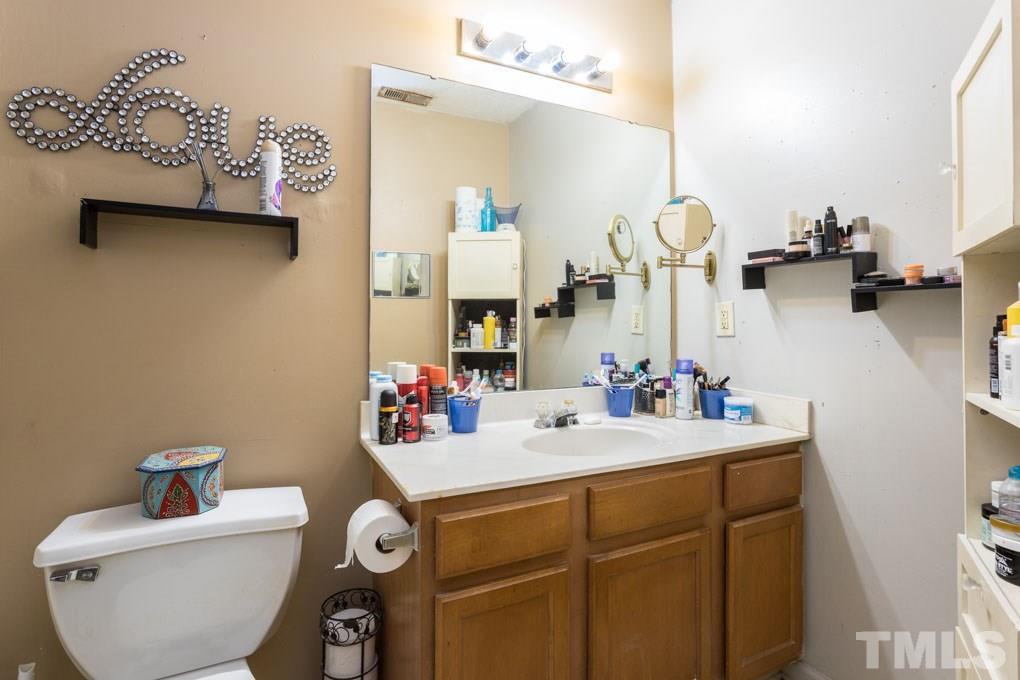 3121 Marcony Way Raleigh, NC 27610 - Photo 22 of 26 a bathroom with a sink and a mirror