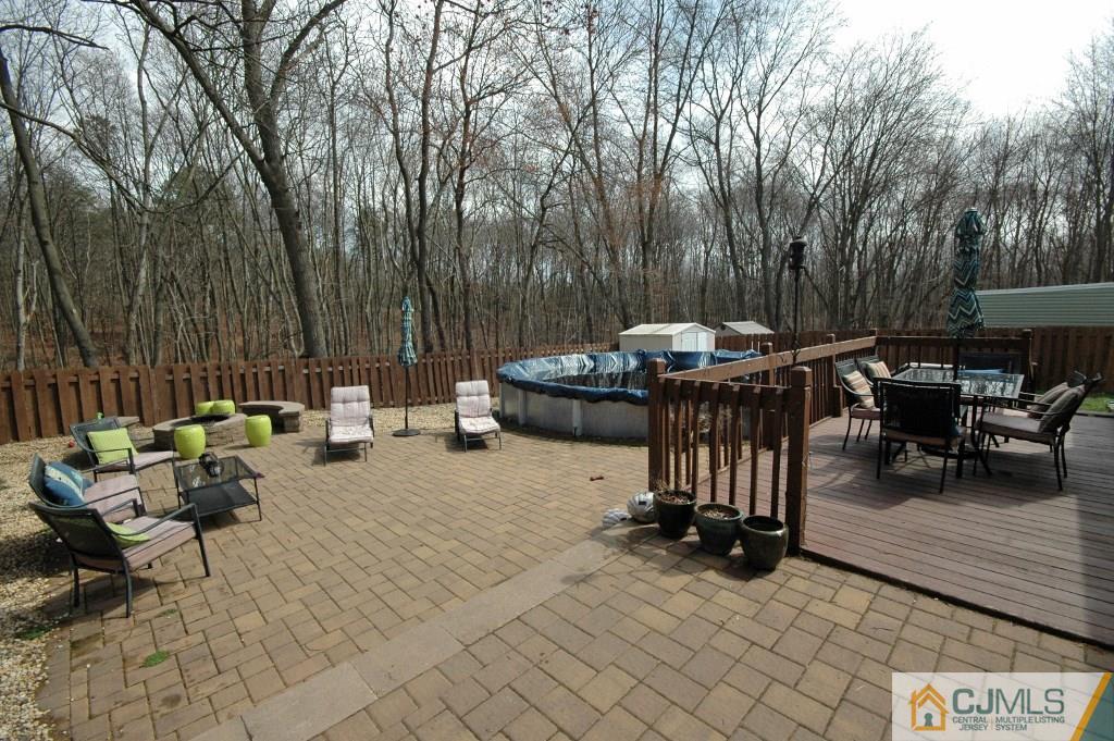 3066 Cheesequake Road Old Bridge, NJ 08859 - Photo 22 of 24 a view of a dinning table and chairs in the patio