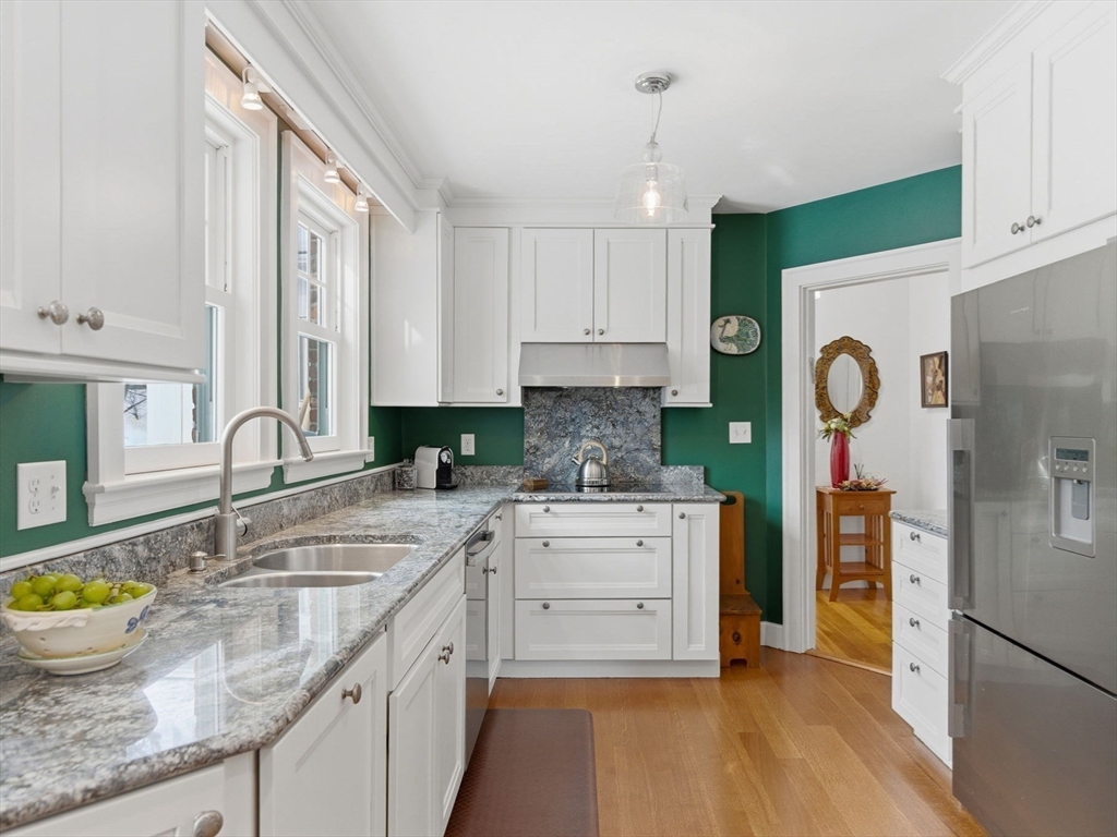 24 Blake Road Brookline, MA 02445 - Photo 11 of 40 a kitchen with stainless steel appliances granite countertop a sink stove and refrigerator