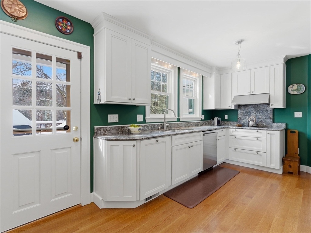 24 Blake Road Brookline, MA 02445 - Photo 12 of 40 a kitchen with granite countertop a stove a sink and a refrigerator