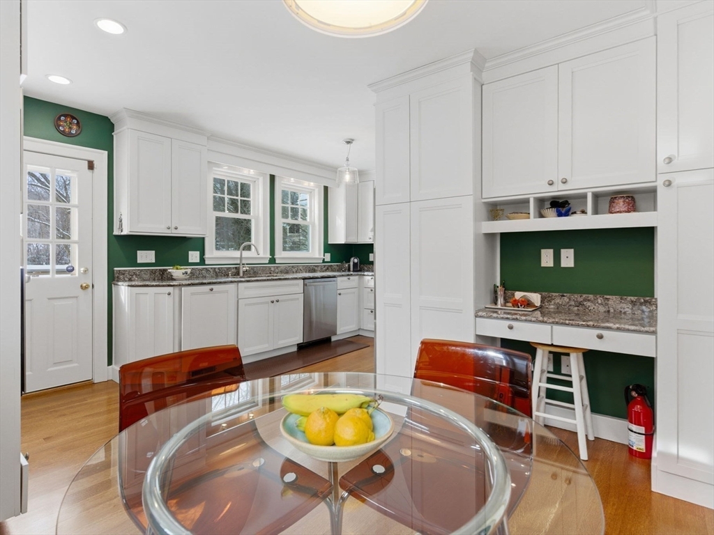 24 Blake Road Brookline, MA 02445 - Photo 13 of 40 a living room with stainless steel appliances furniture a fireplace and a kitchen view
