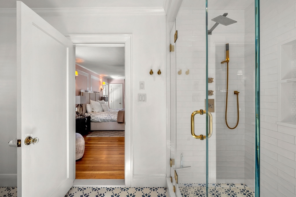 24 Blake Road Brookline, MA 02445 - Photo 24 of 40 a bathroom with a glass shower door
