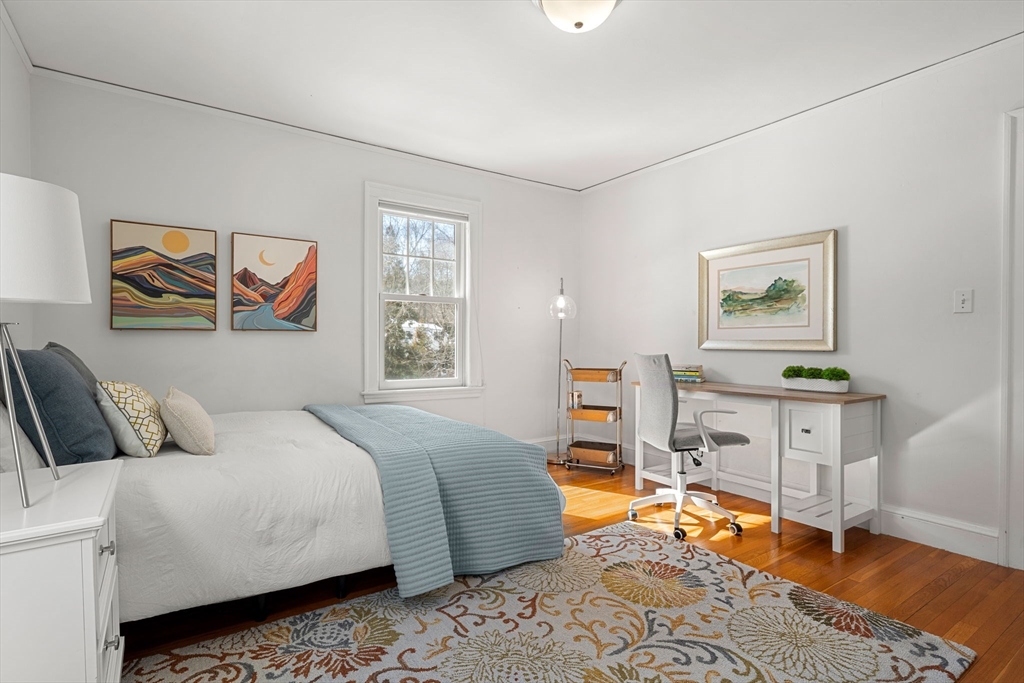 24 Blake Road Brookline, MA 02445 - Photo 26 of 40 a bedroom with a bed and wooden floor