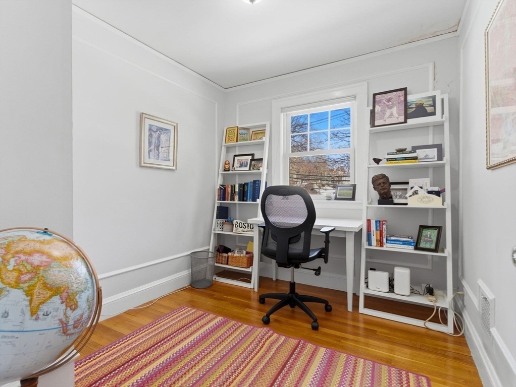 24 Blake Road Brookline, MA 02445 - Photo 30 of 40 a living room with furniture a rug and a wooden floor