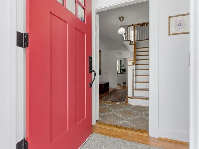 a view of a hallway with a white walls and stairs