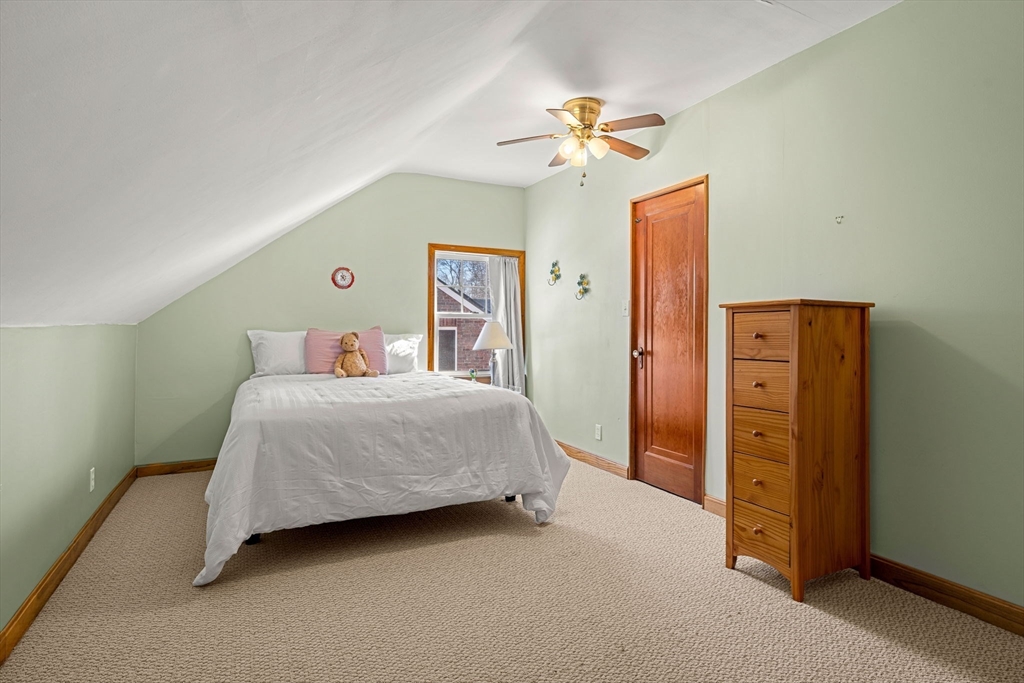 24 Blake Road Brookline, MA 02445 - Photo 32 of 40 a bedroom with a bed and a chandelier