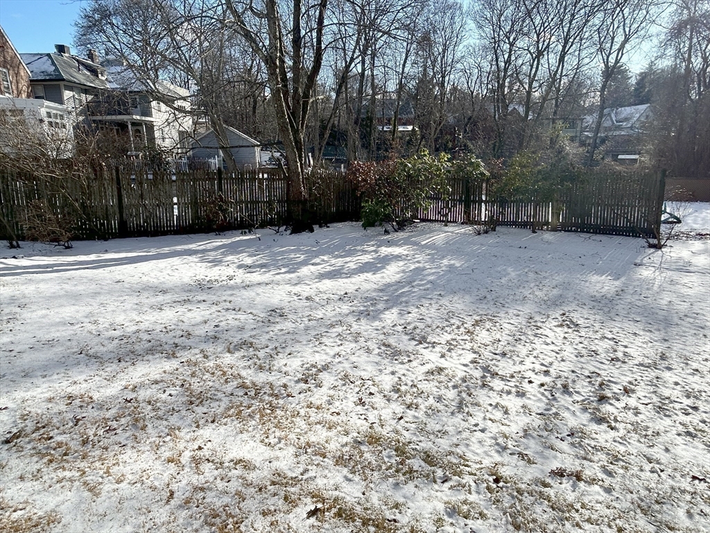 24 Blake Road Brookline, MA 02445 - Photo 39 of 40 a view of a yard covered with snow in front of house