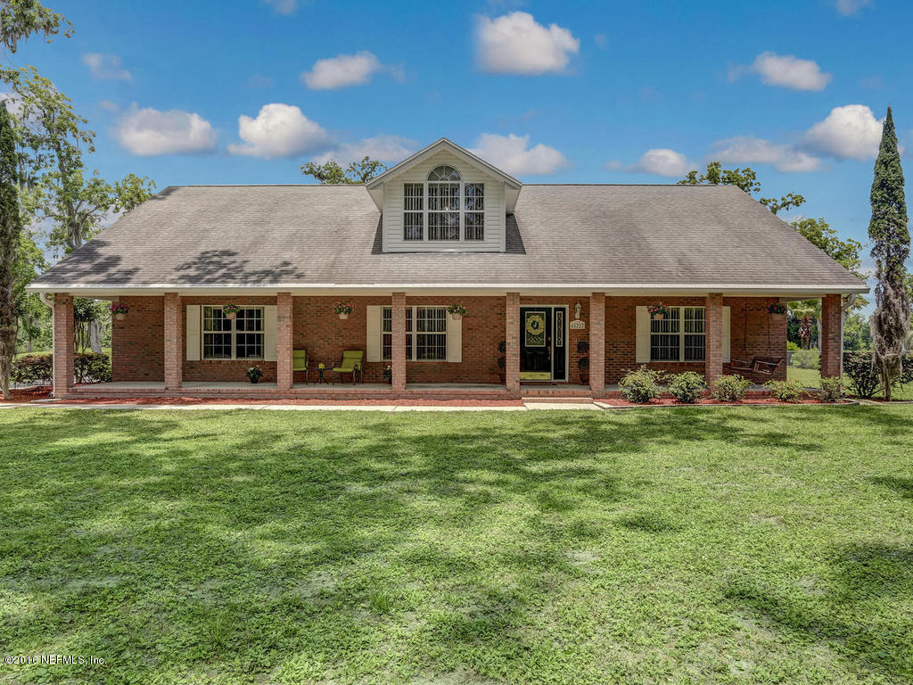 45227 Stratton Road Callahan, FL 32011 - Photo 1 of 42 a front view of a house with a garden
