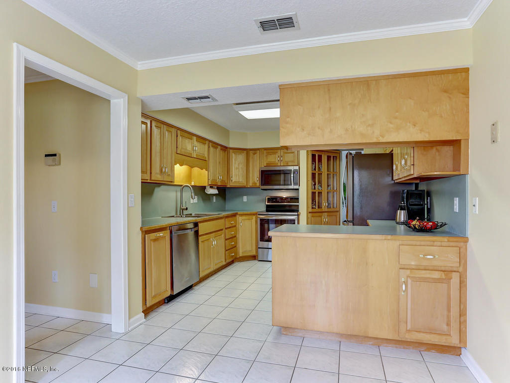 45227 Stratton Road Callahan, FL 32011 - Photo 13 of 42 a kitchen with stainless steel appliances granite countertop a refrigerator and a stove top oven