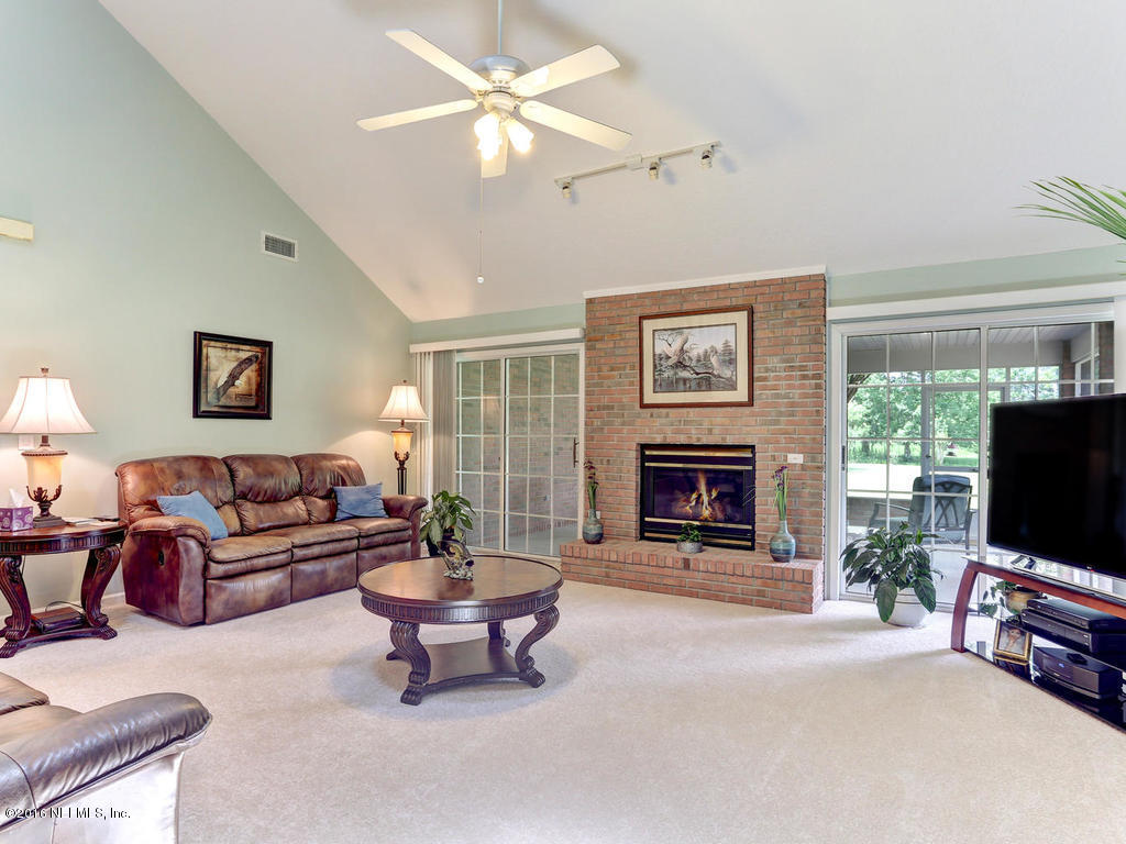 45227 Stratton Road Callahan, FL 32011 - Photo 15 of 42 a living room with furniture a window and a fireplace