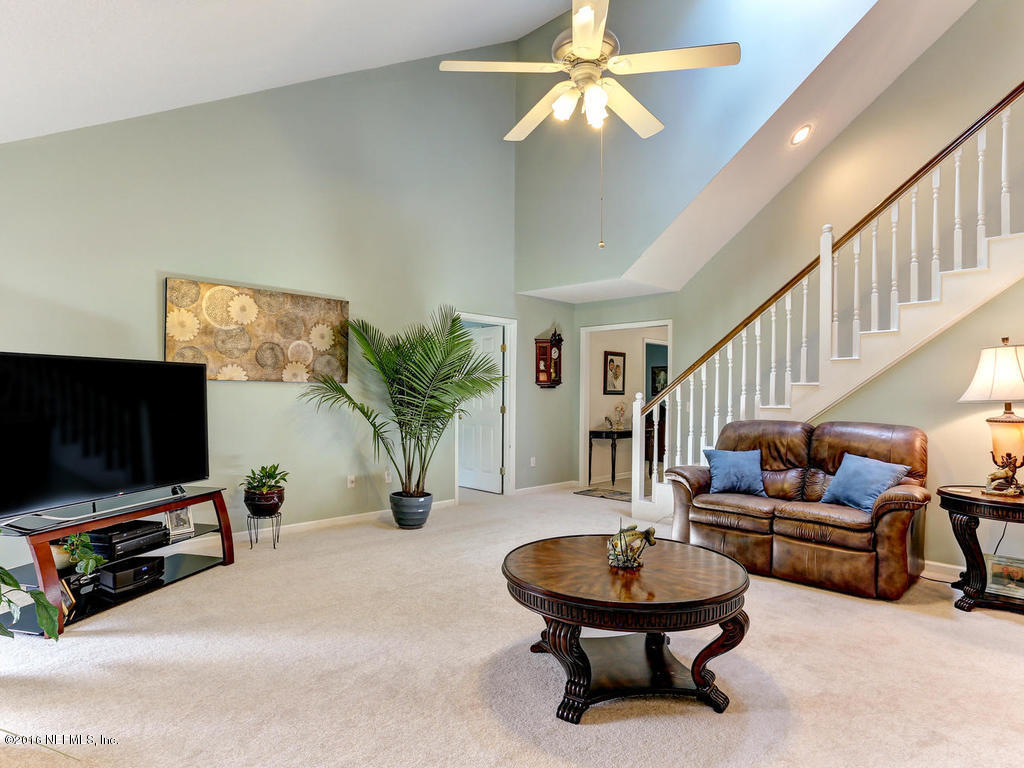 45227 Stratton Road Callahan, FL 32011 - Photo 16 of 42 a living room with furniture and a flat screen tv