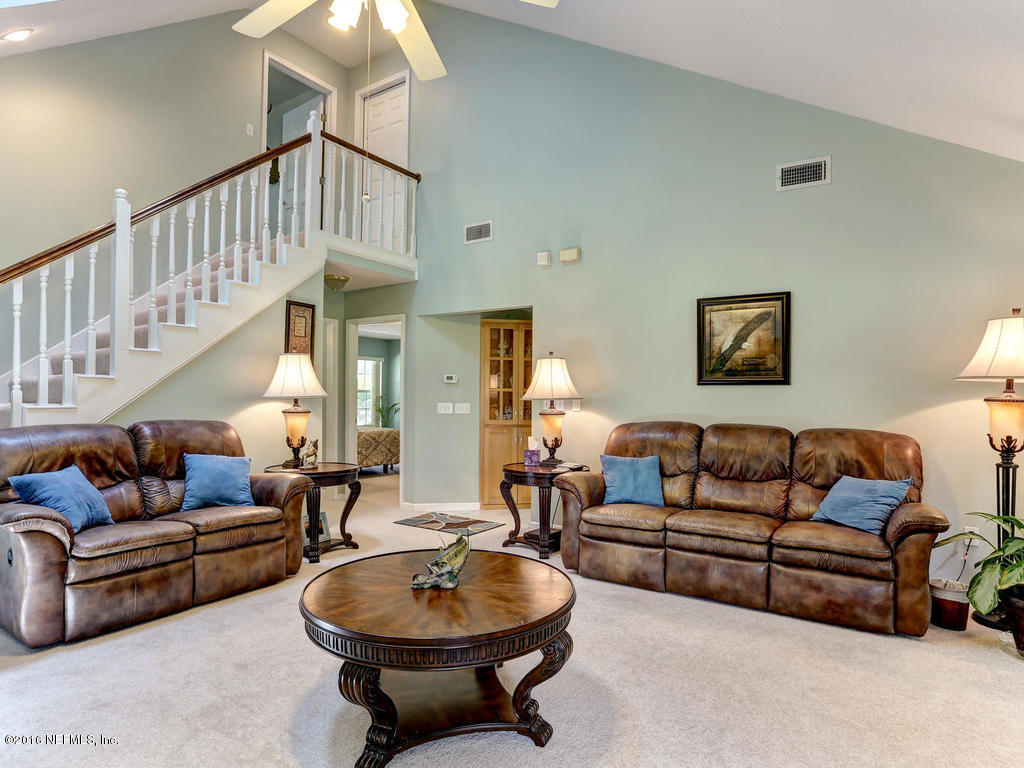 45227 Stratton Road Callahan, FL 32011 - Photo 17 of 42 a living room with furniture a rug and a chandelier