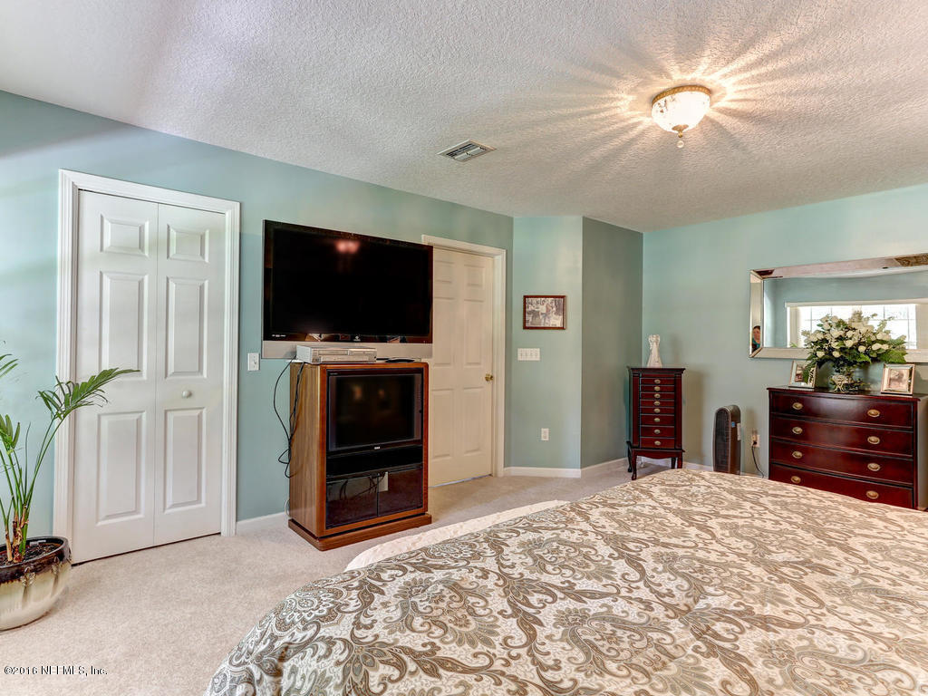 45227 Stratton Road Callahan, FL 32011 - Photo 22 of 42 a bedroom with furniture and a flat screen tv