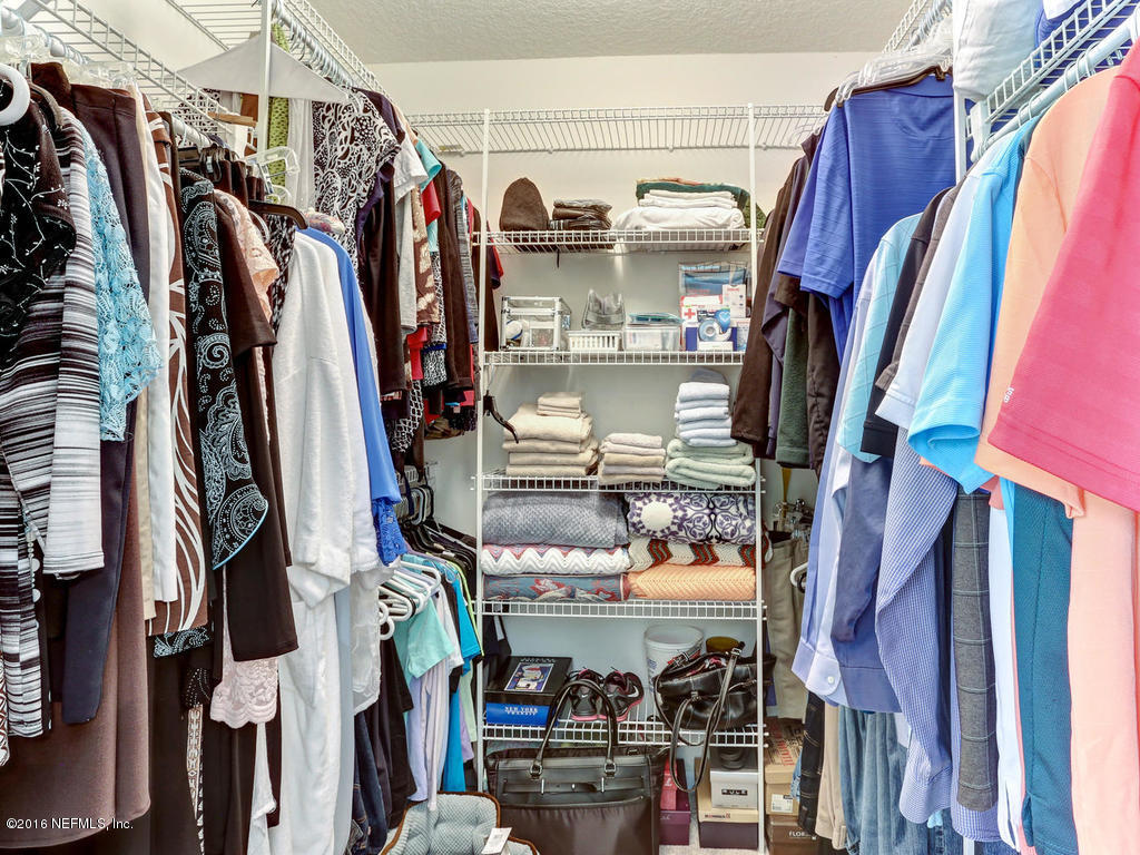 45227 Stratton Road Callahan, FL 32011 - Photo 23 of 42 a view of walk in closet with clothes and shoes