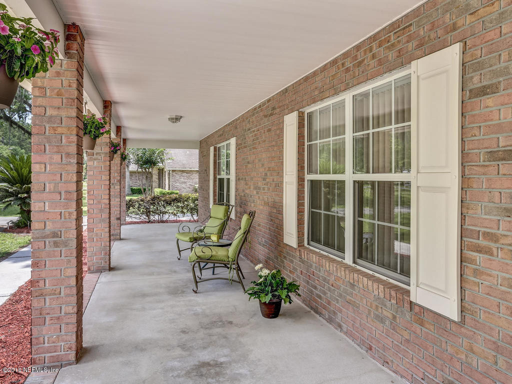 45227 Stratton Road Callahan, FL 32011 - Photo 38 of 42 a view of a porch with chairs and a potted plant