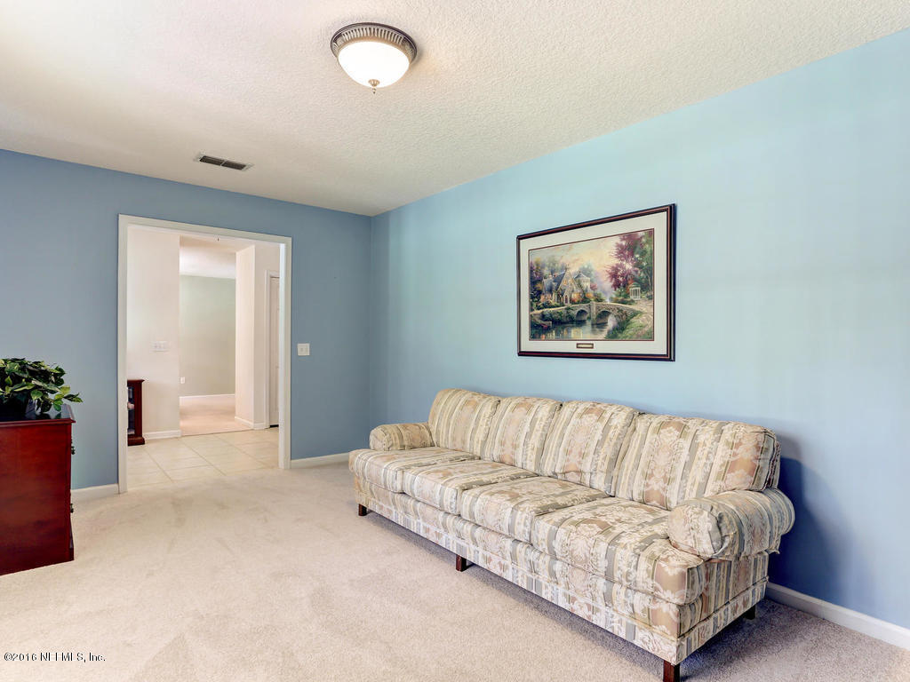 45227 Stratton Road Callahan, FL 32011 - Photo 4 of 42 a living room with a large couch and a potted plant