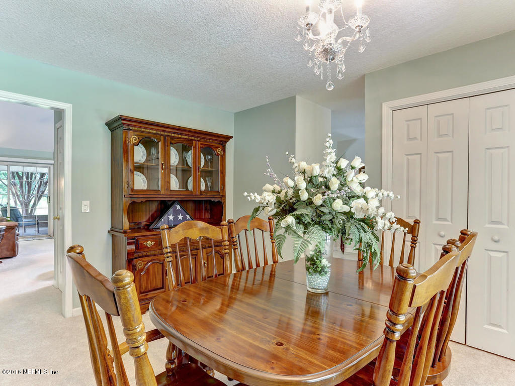 45227 Stratton Road Callahan, FL 32011 - Photo 5 of 42 a dining room with furniture potted plants and wooden floor