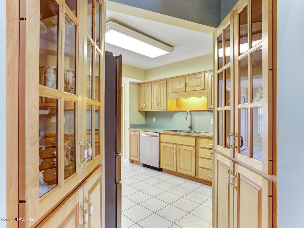 45227 Stratton Road Callahan, FL 32011 - Photo 7 of 42 a kitchen with granite countertop a sink and a refrigerator