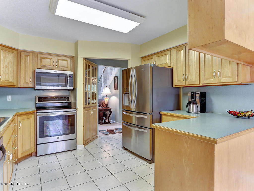 45227 Stratton Road Callahan, FL 32011 - Photo 8 of 42 a kitchen with granite countertop a refrigerator and a stove top oven