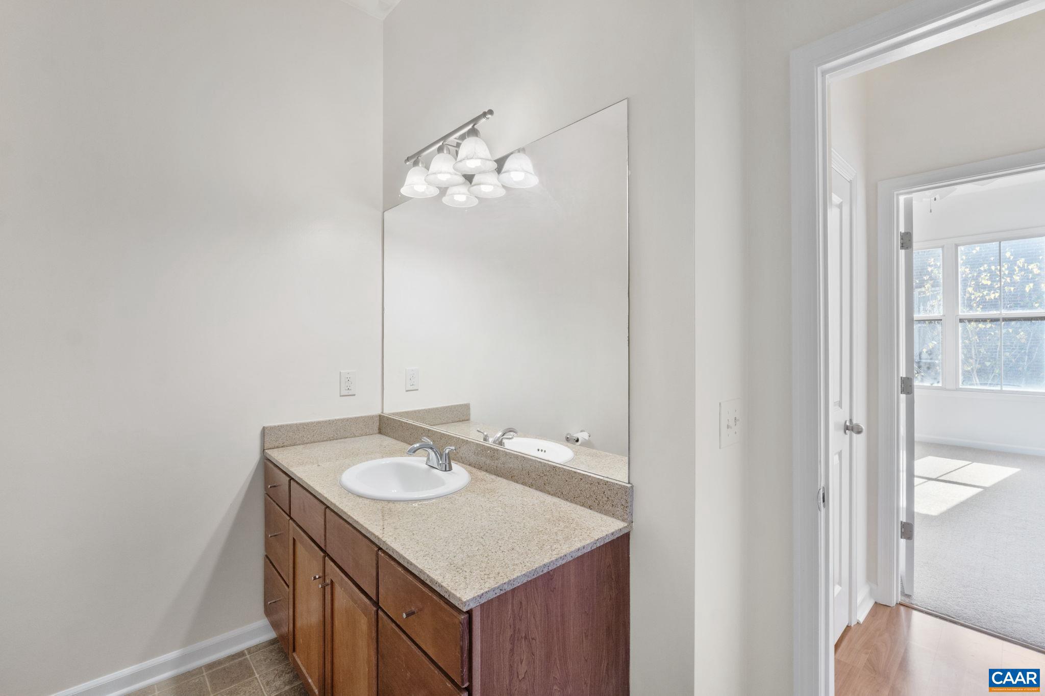 765 Walker Square, Unit 4B Charlottesville, VA 22903 - Photo 14 of 17 a bathroom with a sink vanity and a mirror