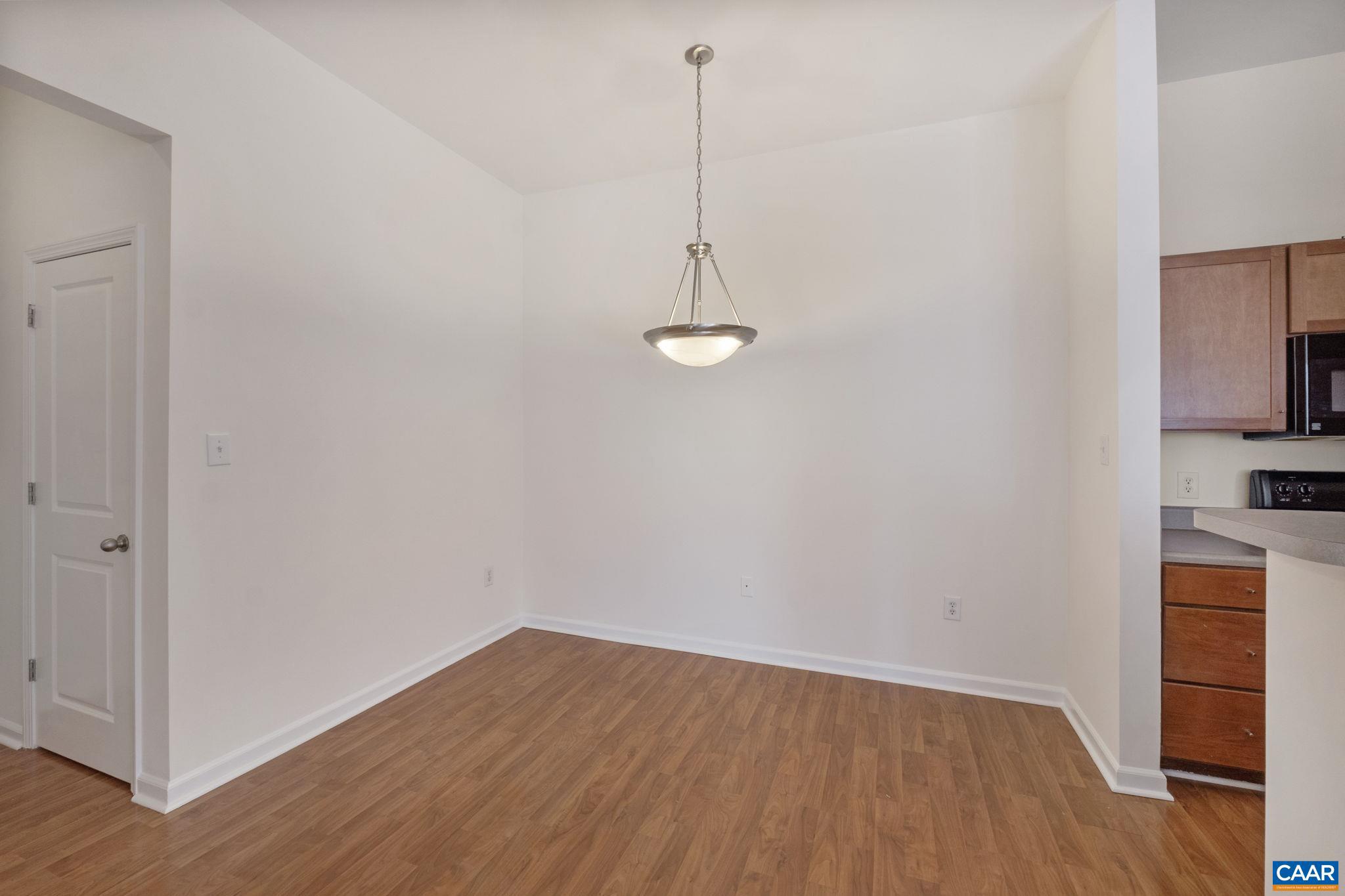 765 Walker Square, Unit 4B Charlottesville, VA 22903 - Photo 4 of 17 a view of a room with wooden floor and cabinets