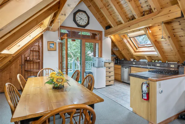 a kitchen with a stove a sink and a window