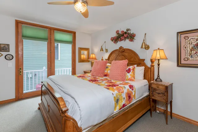 a bedroom with a large bed and a chandelier