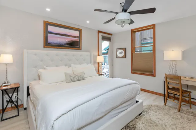 a bedroom with a large bed and a flat tv screen on the dresser