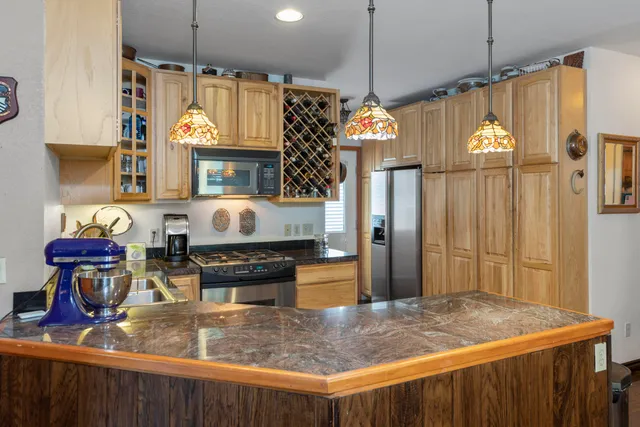 a dining room filled chandelier and wooden floor