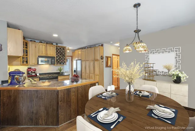 a kitchen with stainless steel appliances kitchen island granite countertop a refrigerator and a stove top oven