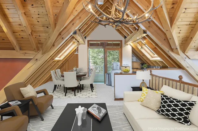 a living room with furniture and a floor to ceiling window