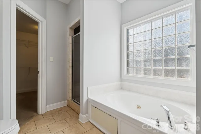 a bathroom with a tub and a shower