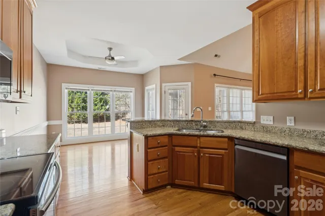 a kitchen with granite countertop a sink and cabinets